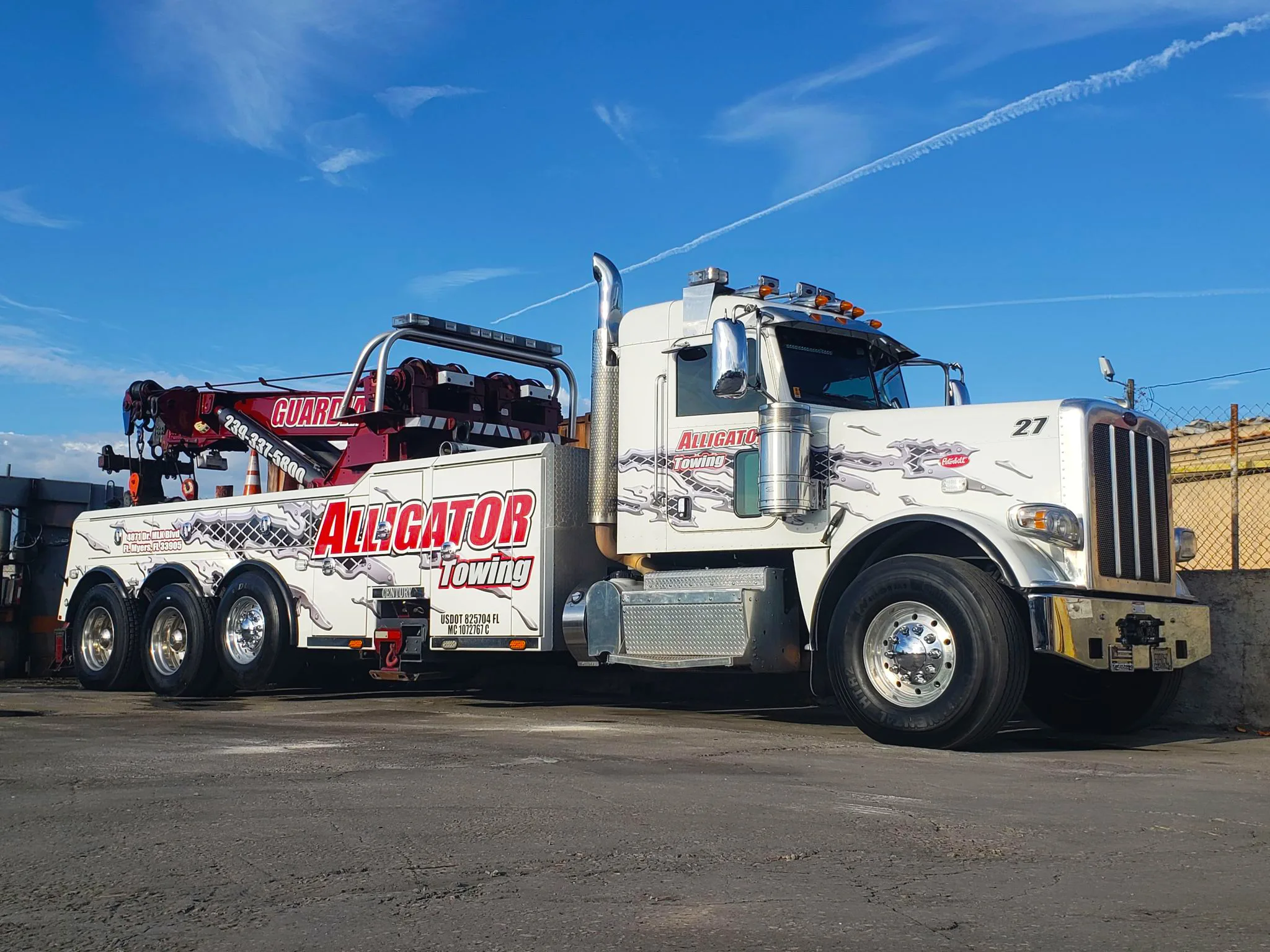 Alligator Towing truck in parking lot